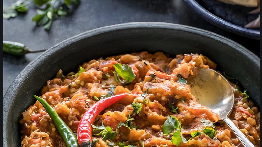 Baingan Bharta · Eggplant purée in sautéed onion and tomatoes with ginger and green peas