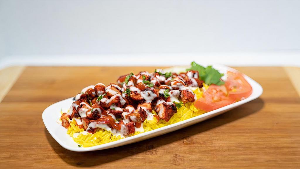 Tandoori Chicken Over Rice · Rice dishes are served with your choice of meat, lettuce, grilled onions, ranch, sriracha and a sprinkle of cajun.
