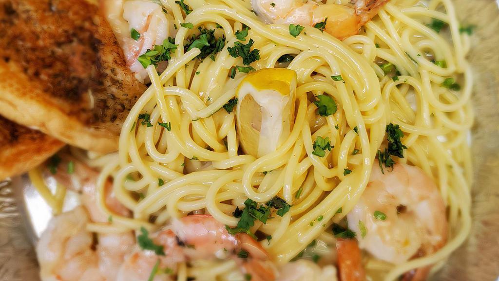 Shrimp Scampi · Shrimp sauteed in white wine, garlic, and lemon butter sauce on a bed of spaghetti.