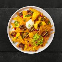 Loaded Nachos · Salted tortilla chips doused in chili, cheese, seasoned ground beef, black olives, tomato, o...