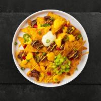 Chili Cheese Nachos · Salted tortilla chips doused in melted nacho cheese and topped with chili.