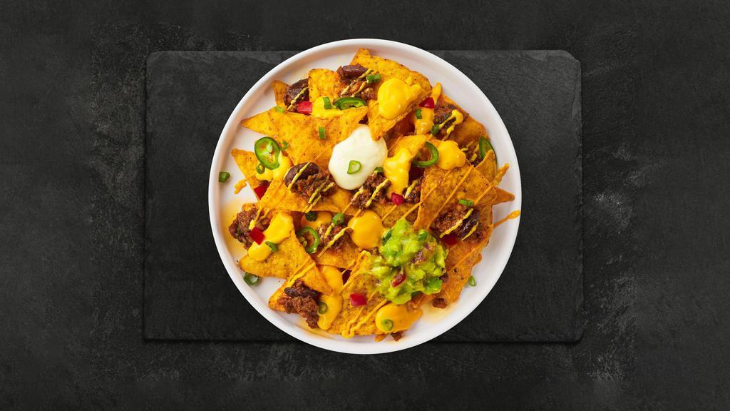 Chili Cheese Nachos · Salted tortilla chips doused in melted nacho cheese and topped with chili.