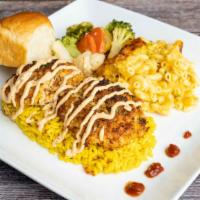 Crab Cakes · Two 4 oz jumbo lump crab cakes on a bed of yellow saffron rice. Sides and dinner roll are su...
