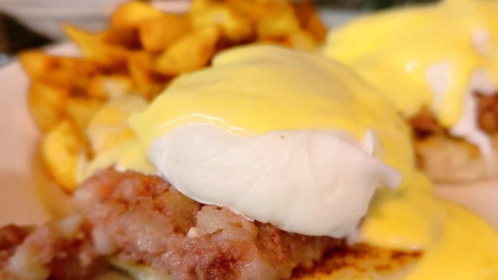 Eggs Irish Benedict · Two dropped eggs on a grilled English muffin and Corned beef hash, then draped with hollandaise sauce.