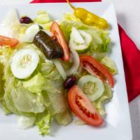 Greek Salad · Ice berg Lettuce, Tomato, Cucumber, Onions, Feta cheese, Olives, Peppercini, Stuffed Grape l...