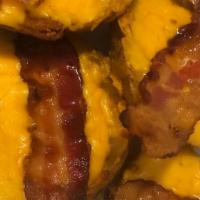 Potato Skins · Four potato halves stuffed with cheddar cheese and topped with bacon; served with a side of ...