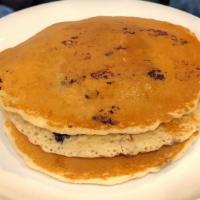 Blueberry Pancakes · Three delicious pancakes and topped with blueberries.