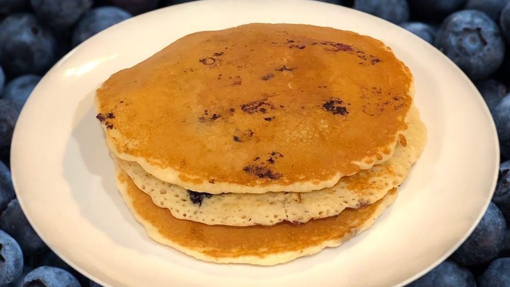 Blueberry Pancakes · Three delicious pancakes and topped with blueberries.