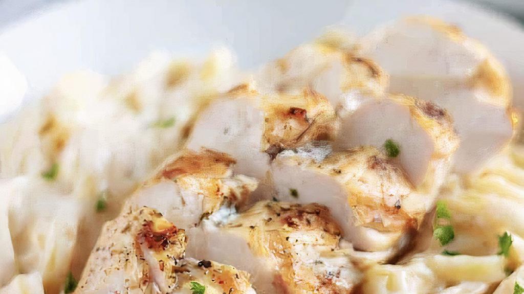 Chicken Alfredo · Fettuccine pasta smothering in our homemade Alfredo sauce, topped with seasoned grilled chicken.