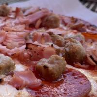 Lots Of Meat Pizza · Pepperoni, salami, Italian sausage, ham, bacon and three cheese blend.
