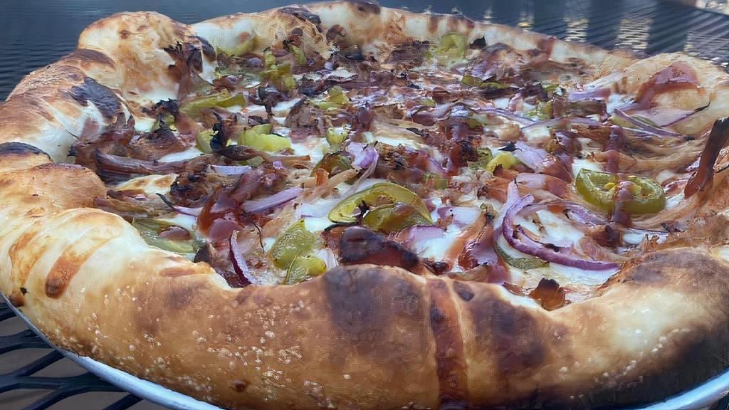 Pulled Pork Pizza · BBQ sauce base, three cheese blend, pulled pork, diced jalapenos and bacon