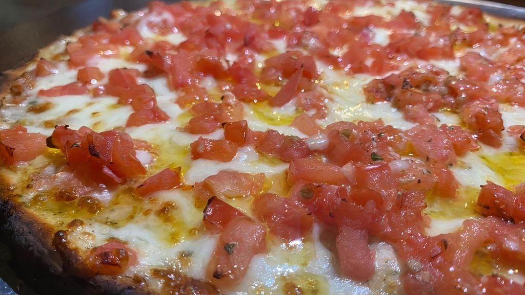 Tomato Pie Pizza · Starts with special garlic butter base fresh tomatoes and basil our house seasoning and a three cheese blend