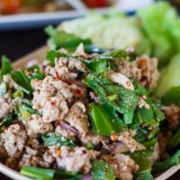 Larb (Comes With Sticky Rice) · Mint leaves, Carrots, Chili, Lime Juice, Onions, Cilantro and Lettuce (With Meat option).