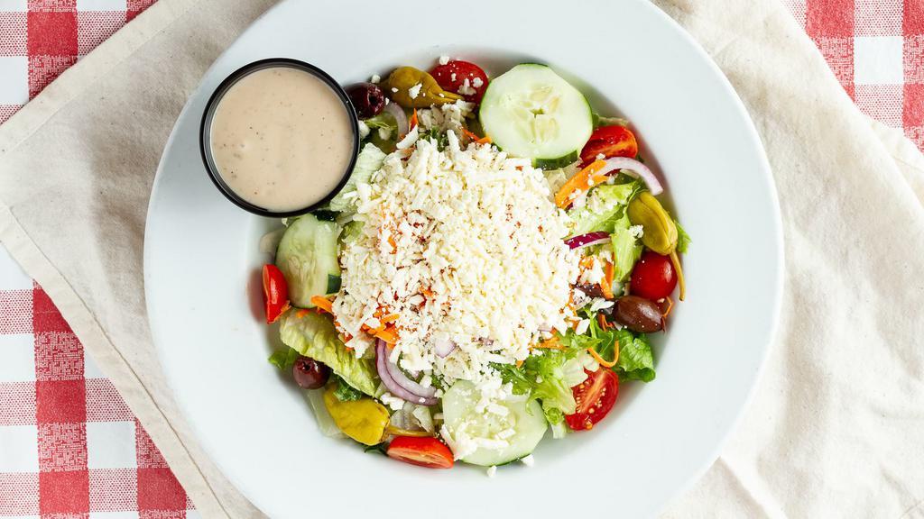 Greek Salad · Lettuce blend, pepperoncini, olives, cucumbers, red onions, marinated chopped tomatoes, and feta cheese.
