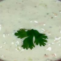 Raita · Homemade fresh whipped yogurt with grated cucumbers, carrots, herbs and Indian spices.
