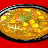 Mattar Paneer · Fresh peas and lightly fried homemade cheese cubes in a mildly spiced sauce.