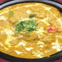 Chicken Korma · Pieces of chicken flavored with coconut and gently simmered in yogurt with spice & nuts.