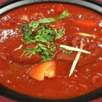 Lamb Vindaloo · Lamb cooked in hot-spiced sauce with potatoes.