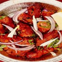 Lamb Seekh Kebab · A delicacy of minced meat, flavored with fresh herbs and spices cooked in the clay oven on a...