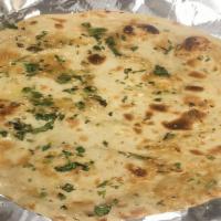Garlic Naan · White flour bread sprinkled with fresh garlic and baked in tandoor clay oven.