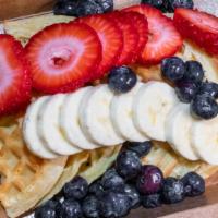Protein Waffles · Topped with strawberries, bananas, blueberries, maple syrup or drizzle.
