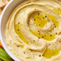 Hummus · Blend of garbanzo beans, tahini, fresh garlic and lemon. Topped with extra virgin olive oil ...