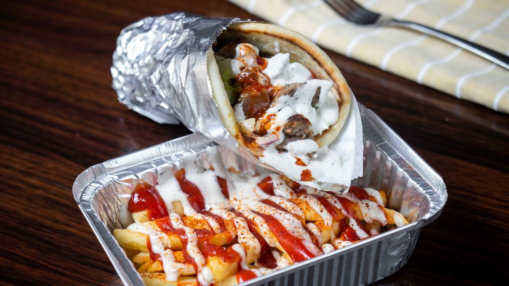 Gyro Wrap Come With Fries · gyro  topped with lettuce, tomatoes, red onion ,cucumber  white sauce and spicy red sauce. Wrapped in warm pita bread.