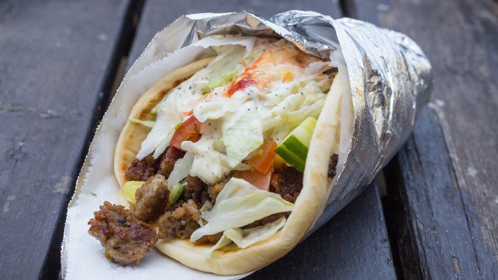 Beef Shawarma Wrap Come With Fries · Beef shawarma  topped with lettuce, tomatoes, cucumber red onion  white sauce and spicy red sauce. Wrapped in warm pita bread.