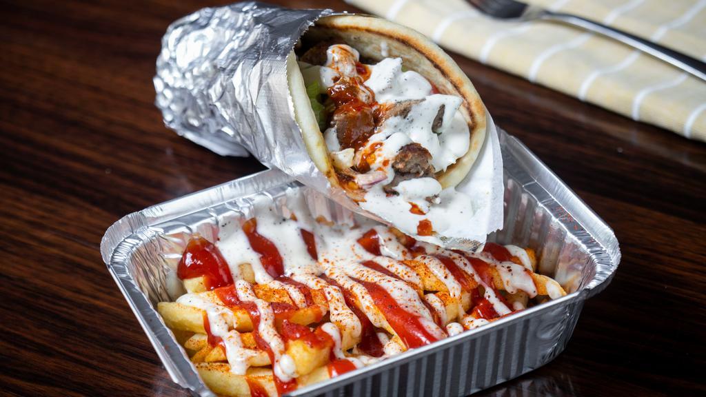 Combo Wrap · grill chicken and gyro topped with lettuce, tomatoes  red onion  cucumber  , white sauce and spicy red sauce. Wrapped in warm pita bread.,side fries