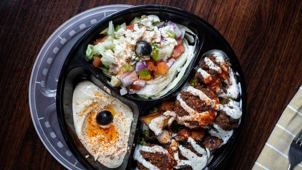 Veggie Plate · Falafel and hummus served on top of Mediterranean rice and a Greek feta and olive salad. Topped with white and red sauce.