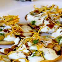Aloo Papdi Chaat · crispy Papdi topped with potatoes, onions, chickpeas, chutneys, curd and spices