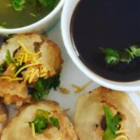 Pani Puri  · Round, hollow puri, filled with a mixture of flavored water, tamarind chutney, chili, chat m...