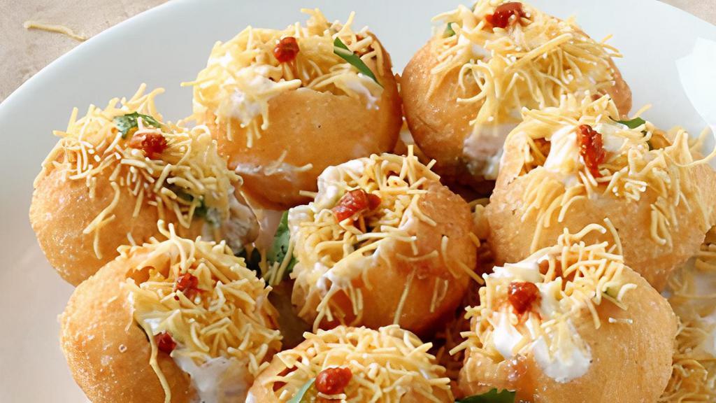 Sev Dahi Puri · Small crispy puffed breads stuffed with boiled potato, chick peas, sprouted beans and topped with various chutneys