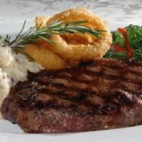 New York Strip Steak (12 Oz) · Angus center-cut, grilled to your order, topped with garlic butter and finished with frizzle...