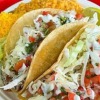 Two Grilled Fish Tacos · Grilled fish served on corn tortillas covered with cabbage, zesty white sauce, our mild sauc...