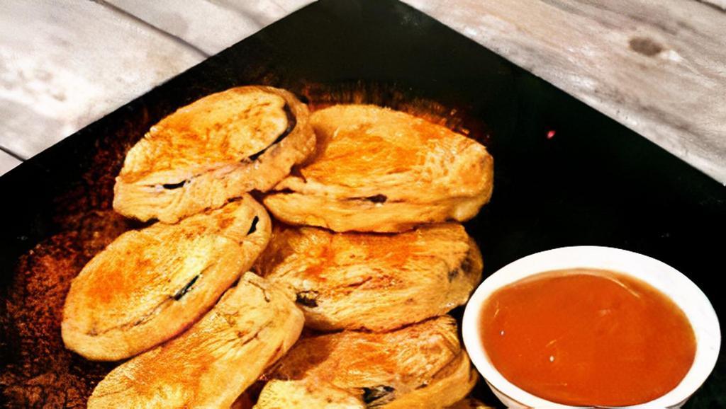 Eggplant Fritters · Eggplant dipped with small mass besan flour batter fried snack.