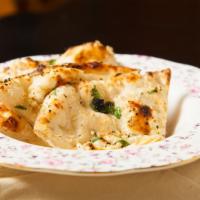 Garlic Naan · Indian flatbread flavored with garlic and butter.