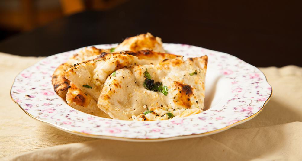 Garlic Naan · Indian flatbread flavored with garlic and butter.