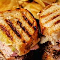 Sandwich Cubano · Roast pork, ham, swiss cheese, mustard and thinly slice pickles with french fries.