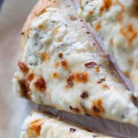 White Pizza · Basted With Oil, Sprinkled With Garlic & Topped With Oregano, Mozzarella & Cheddar Cheese.
