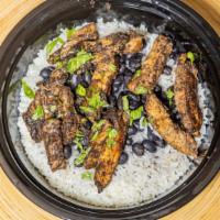 Jamaican Jerk Chicken · Jamaican-style marinated jerk kitchen, black beans on long grain rice. This is the real thin...