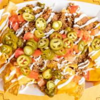 Super Nachos · A large order of crispy deep fried corn tortilla chips smothered with cheddar cheese sauce, ...
