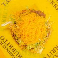 Tostada · A flat, crisp, deep fried corn tortilla covered with refried beans, mild red sauce, and topp...
