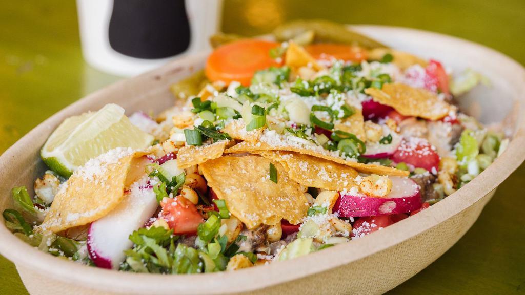 Taco Salad · Your choice of meat, and beans on a bed of lettuce served up with onion, tomato, cilantro, corn, radish, cotija cheese, chipotle crema, radish, lime, and chips.