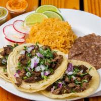 Carne Asada Taco Platter · Three grilled steak tacos served with Mexican rice, and refried beans. Topped with cilantro,...