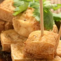 A 14. Golden Triangle · Crispy fried tofu. Served with sweet and sour sauce topped with ground peanuts.