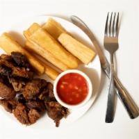 Yuca Con Chicharron · Fried yucca (cassava) served with fried pieces of pork and curtido (marined cabbage).