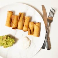 Tacos Dorados · Rolled crispy chicken taquitos, served with guacamole and sour cream.