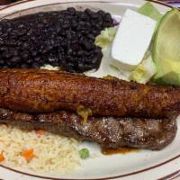 Plato Típico · A typical Salvadorean meal. NY strip with a fried plantain, avocado, rice, beans, and cuajada.
