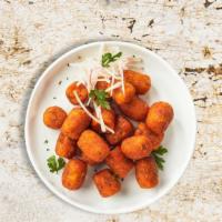 Food For Tots · Shredded sweet potatoes formed into tots, battered, and fried until golden brown. Served wit...